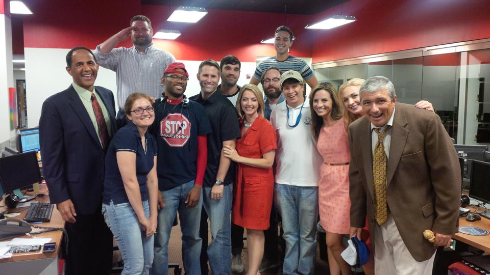 Amanda with her co-workers in the newsroom
